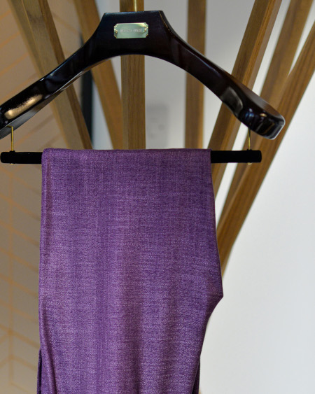 Purple bamboo trousers on a hangar