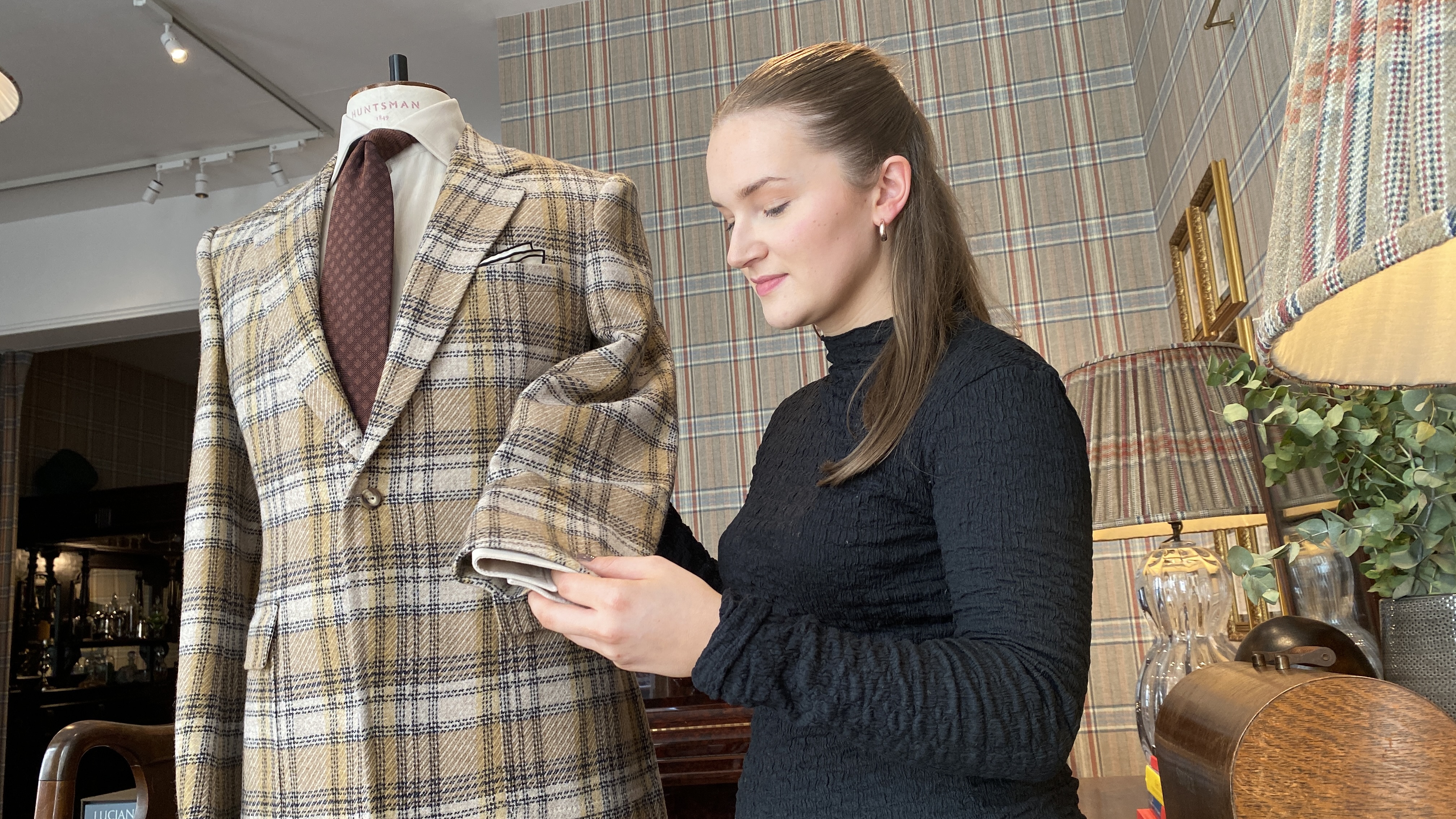Lois looks at a jacket made from her winning fabric